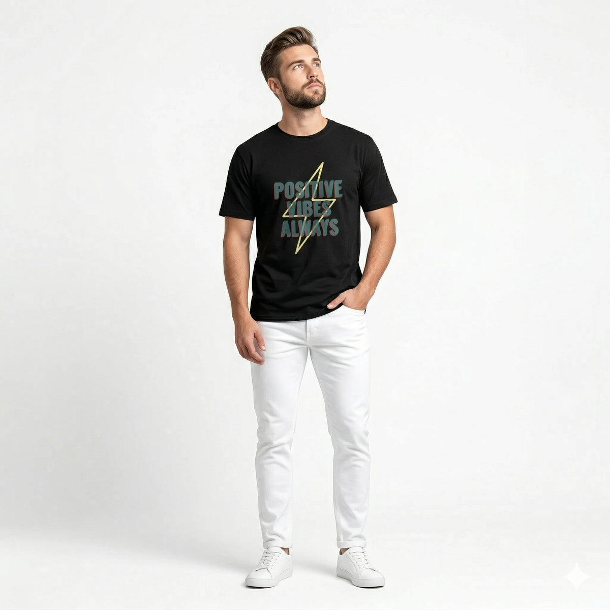 Man wearing a black t-shirt with 'Positive Vibes Always' text and white pants on a light gray background
