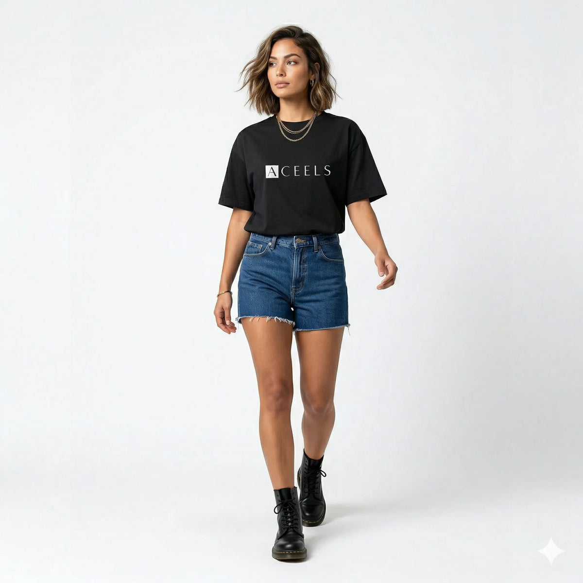 Woman wearing a black t-shirt with 'ACEELS' logo in an indoor setting