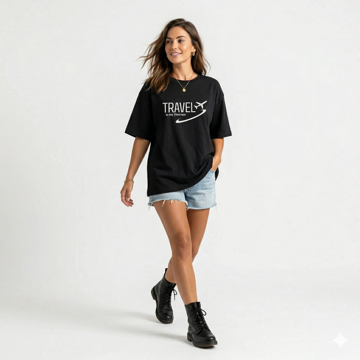 Woman wearing a black t-shirt with 'Travel is my Therapy' text and airplane graphic on a gradient background