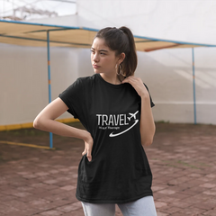 Woman wearing a black t-shirt with 'Travel' text and airplane icon outdoors.