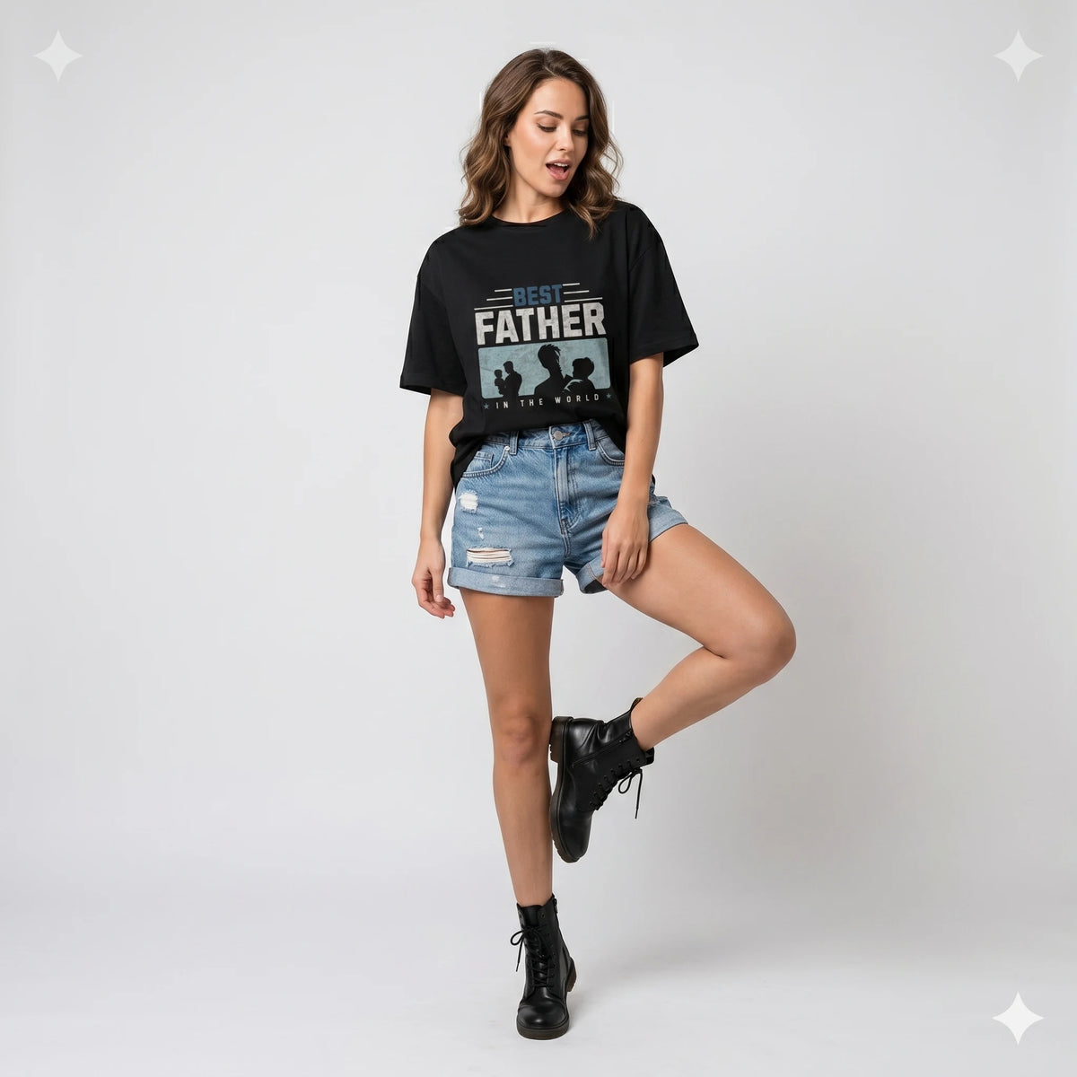 Woman wearing a black t-shirt with 'Best Father in the World' text and denim shorts on a white background