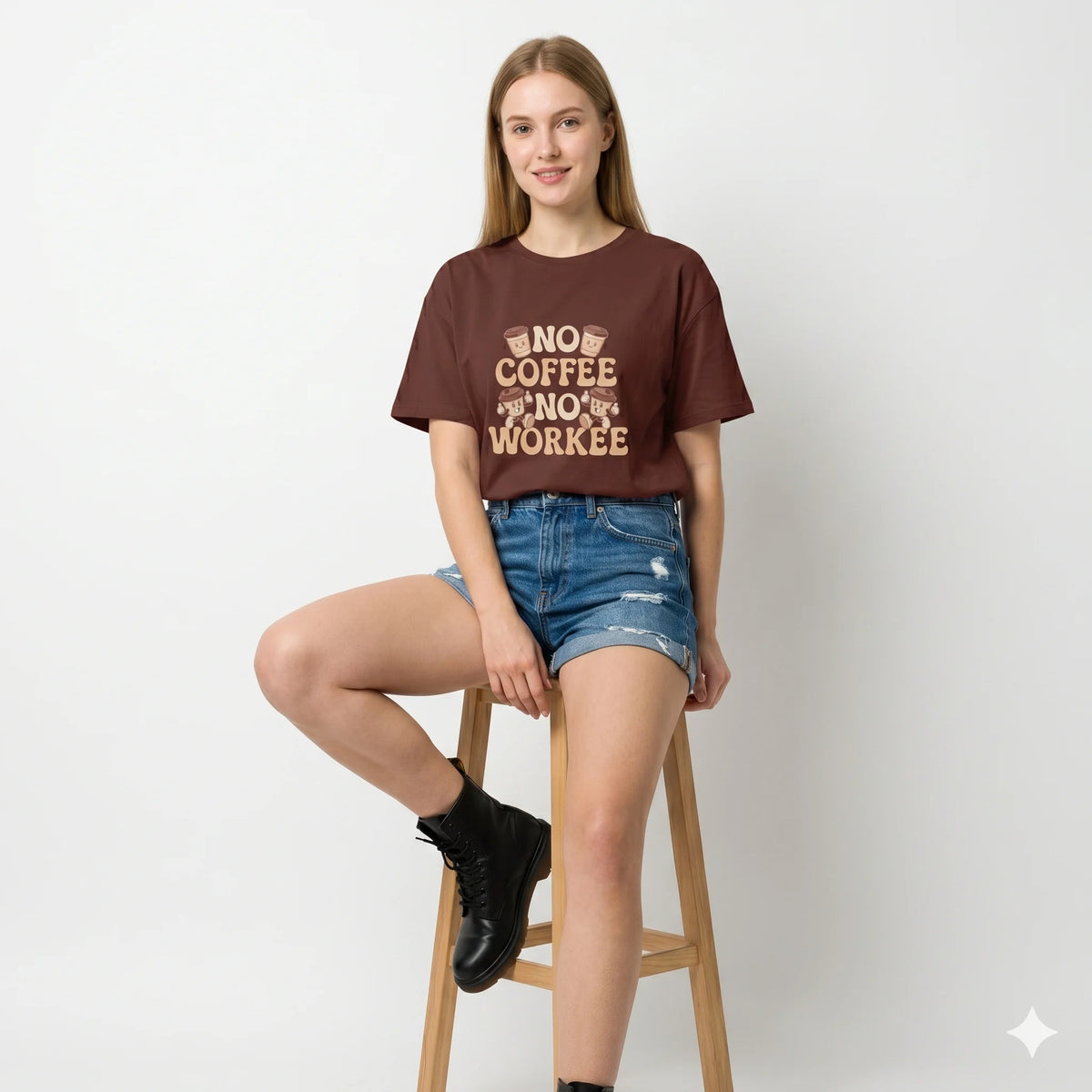 Woman wearing a maroon t-shirt with text, holding a coffee cup outdoors.