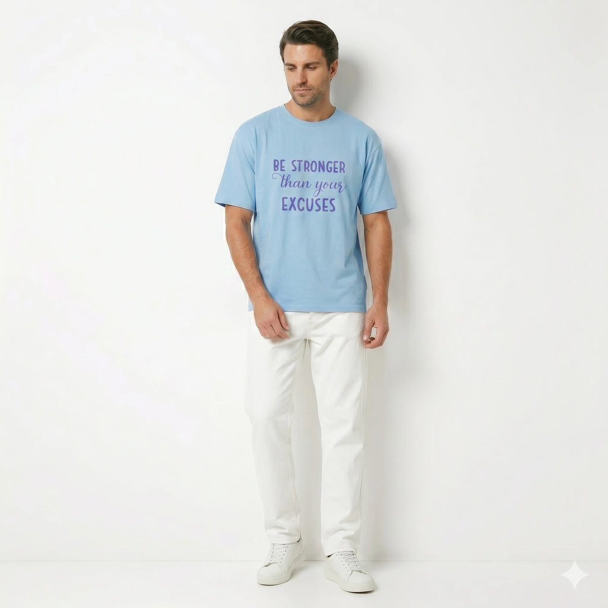 Man wearing a light blue t-shirt with motivational text on a white background