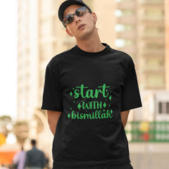 Person wearing a black t-shirt with green text in an urban setting