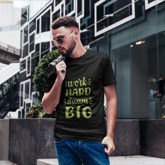 Man wearing a black t-shirt with motivational text in an urban setting