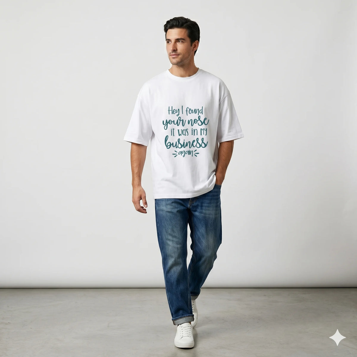 Man wearing a white t-shirt with text in a decorative room.