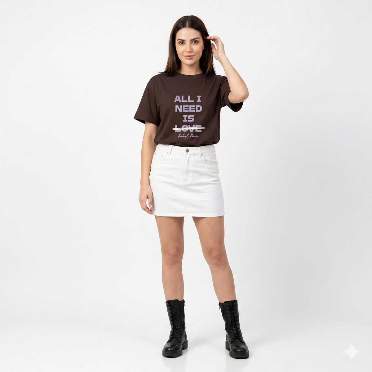 Woman wearing a brown t-shirt with text and a white skirt on a white background