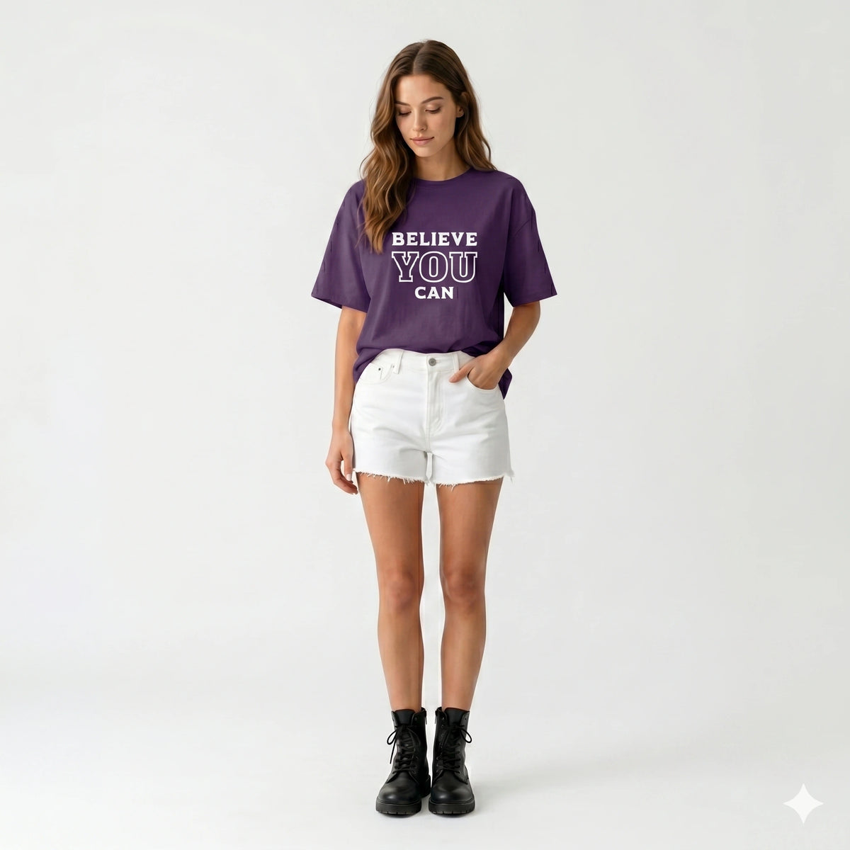 Woman wearing a purple t-shirt with 'BELIEVE YOU CAN' text on a white background