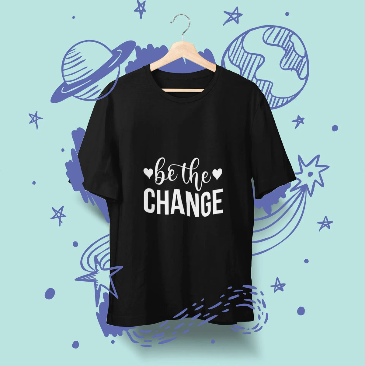 Black t-shirt with 'be the change' text on a blue background with space-themed illustrations