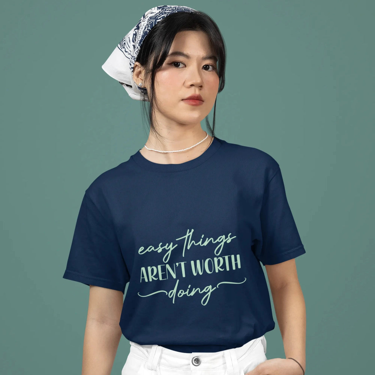 Person wearing a navy blue t-shirt with text on a solid background