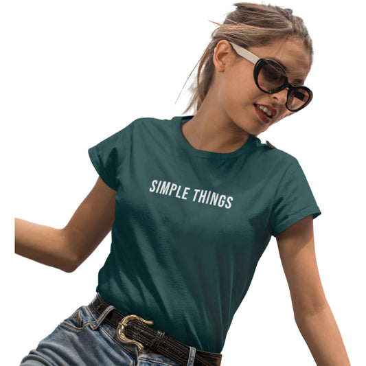 Person wearing a teal t-shirt with 'SIMPLE THINGS' text on a white background