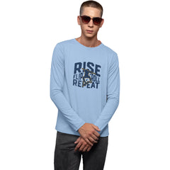 Man wearing a light blue long-sleeve shirt with text and graphics on a white background