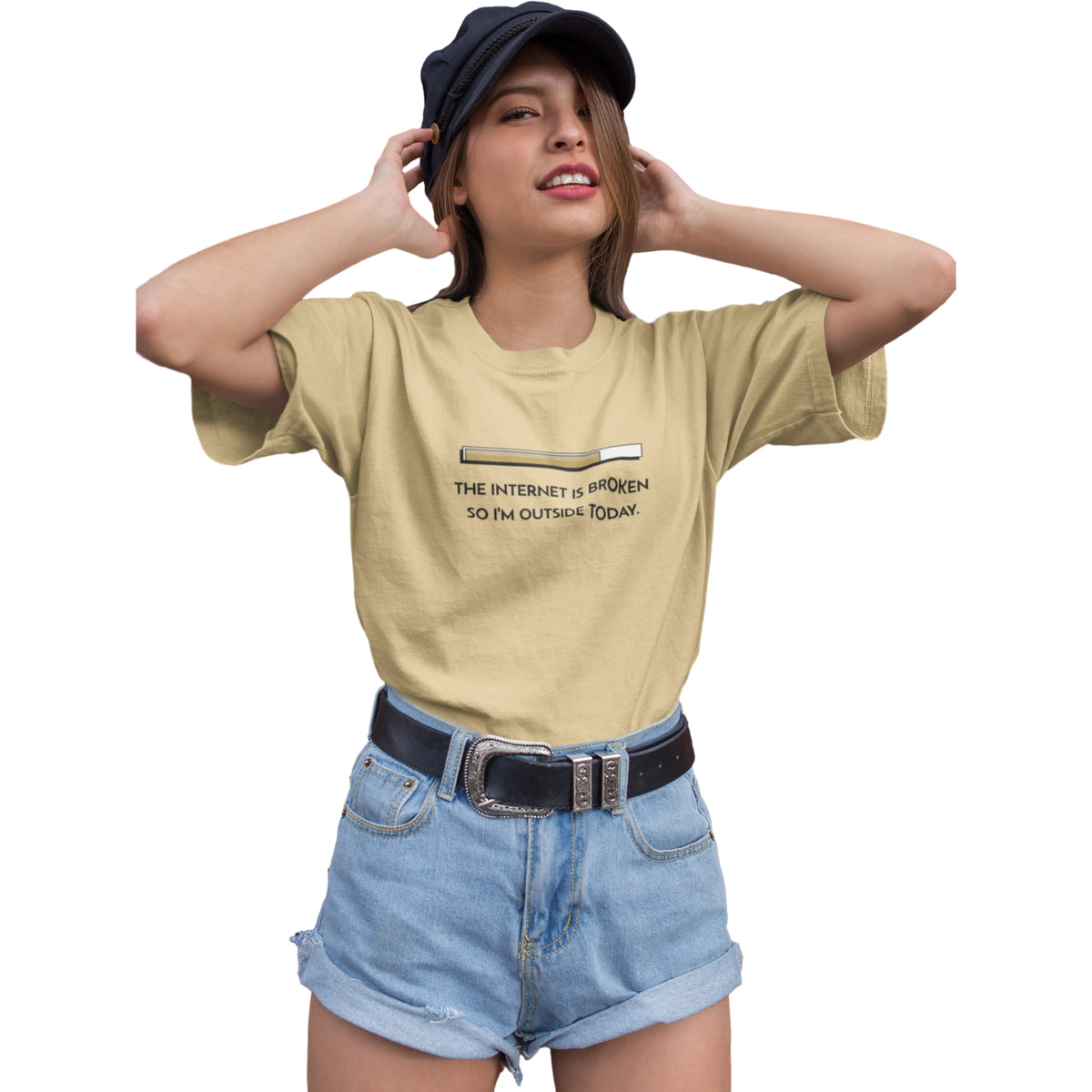 Woman wearing a beige t-shirt with text and denim shorts on a white background