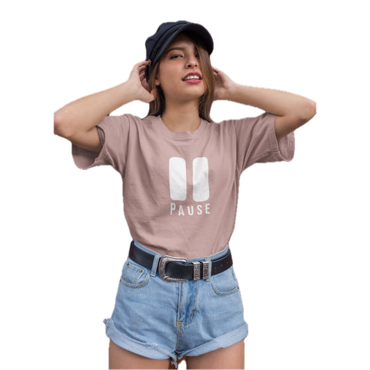 Woman wearing a pink t-shirt with 'PAUSE' design, blue shorts, and a black cap on a white background