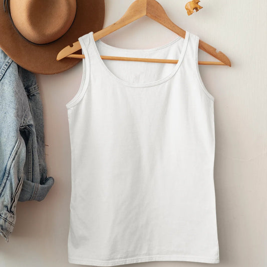 White tank top on a wooden hanger with a brown hat and denim jacket on a white wall.