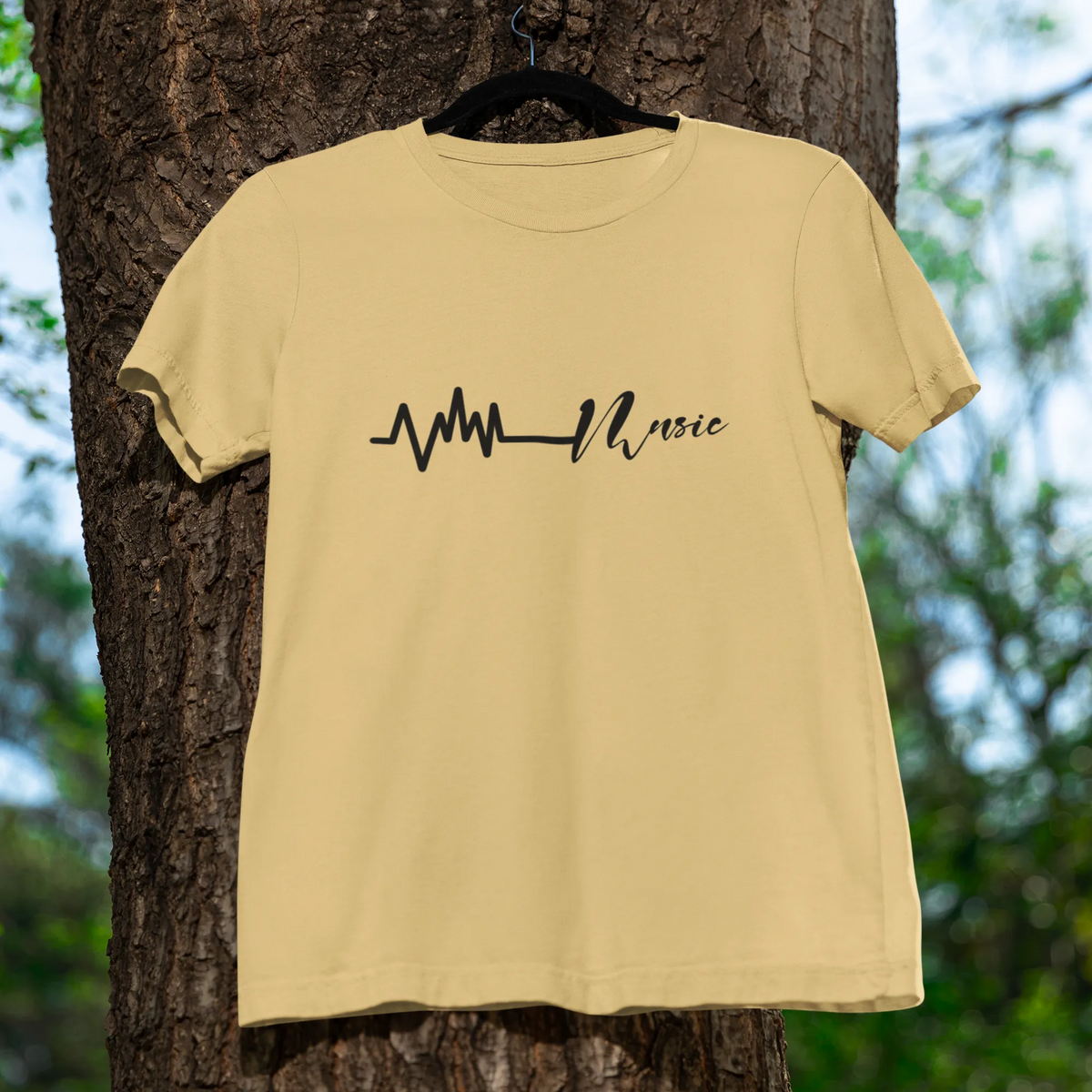 Beige t-shirt with a black design hanging on a tree
