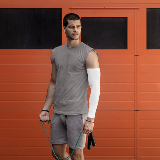 Man holding a jump rope in front of an orange wall