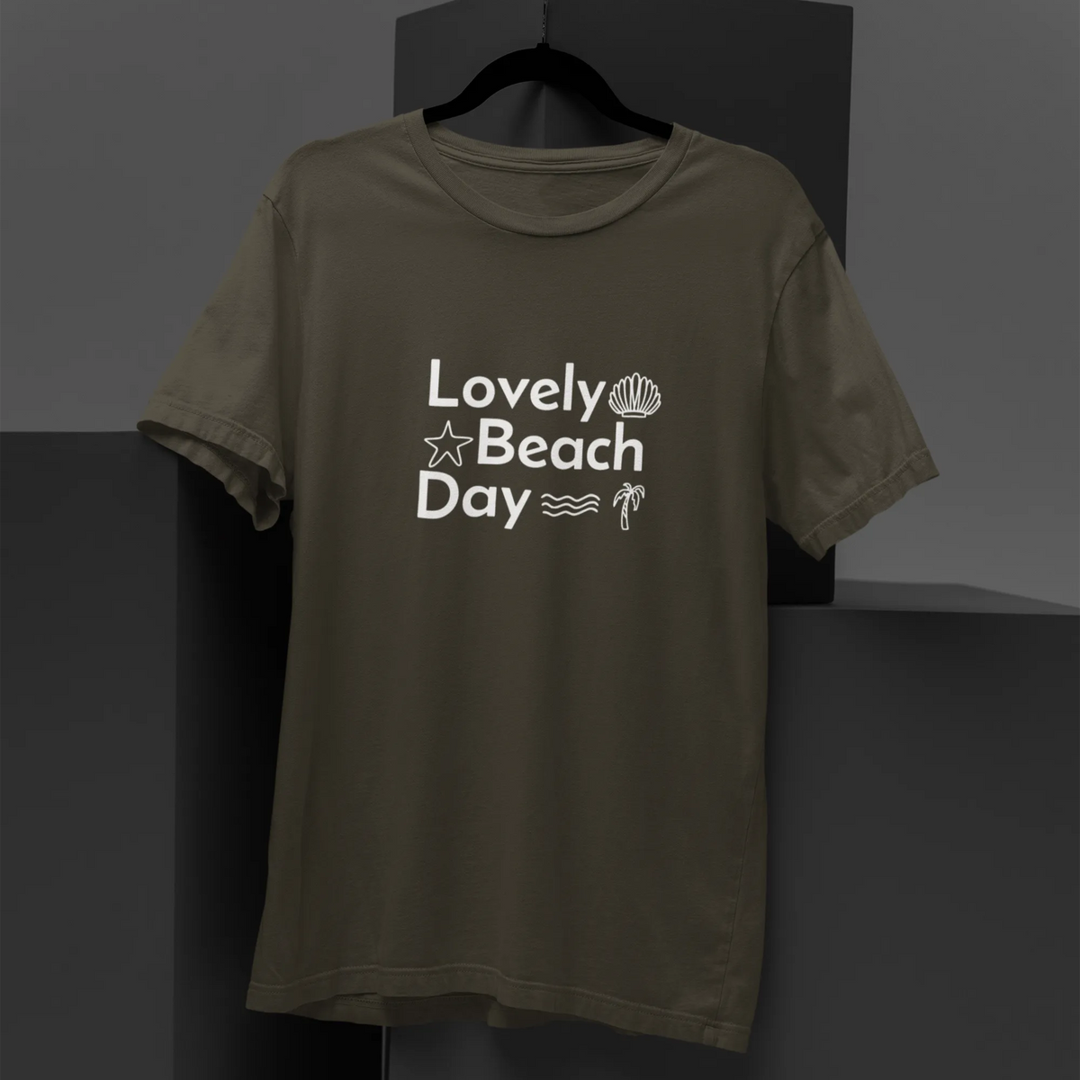 Green t-shirt with 'Lovely Beach Day' text on a black background