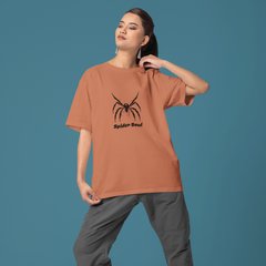 Person wearing a brown t-shirt with a spider design on a blue background