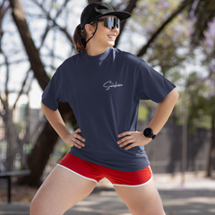 Woman in athletic wear posing outdoors with trees in the background