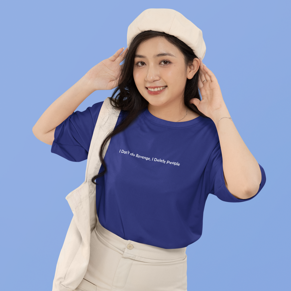 Woman wearing a blue t-shirt with text and a beige skirt against a blue background