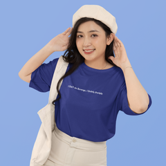 Woman wearing a blue t-shirt with text and a beige skirt against a blue background