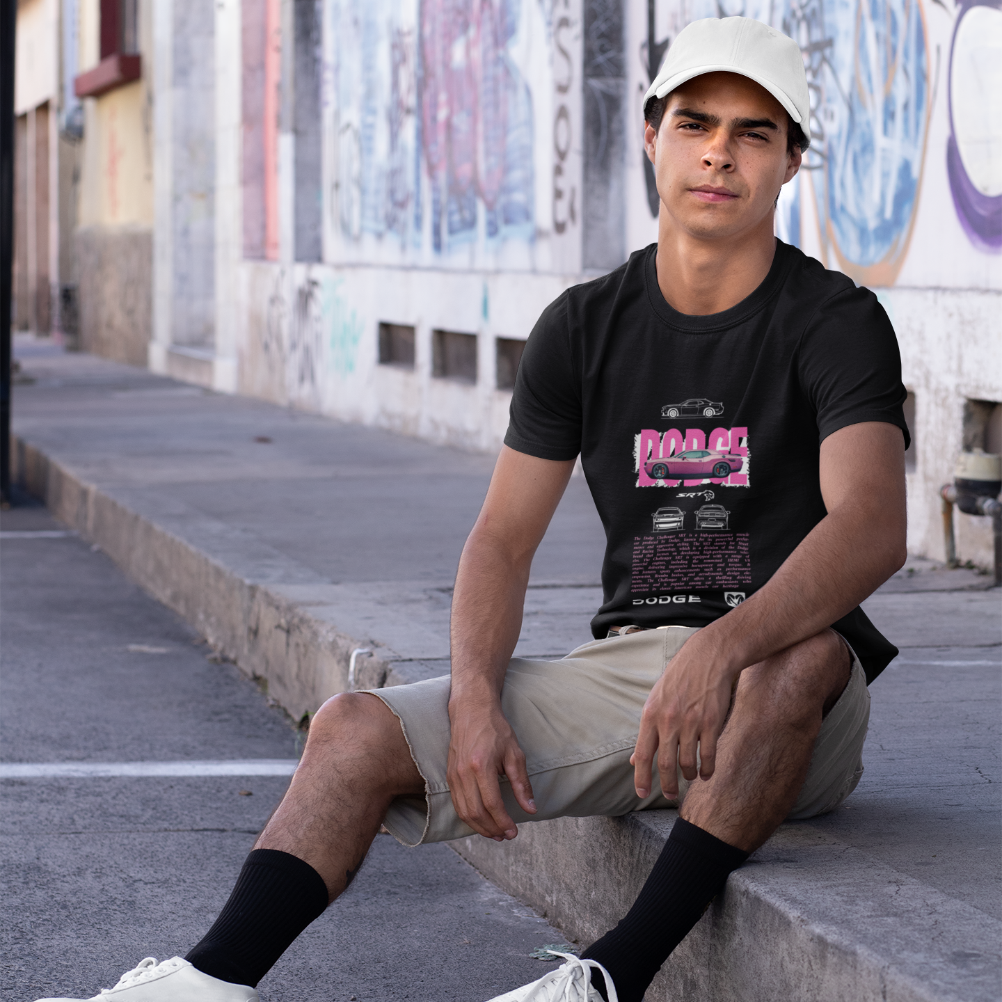 Person sitting on a ledge with graffiti in the background