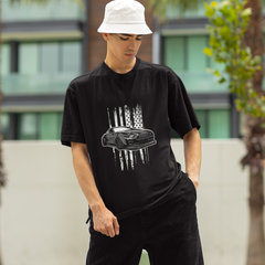 Person wearing a black t-shirt with a graphic design outdoors
