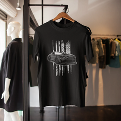 Black t-shirt with car graphic design on a hanger in a store setting