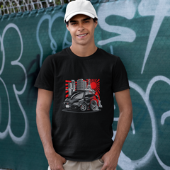 Man wearing a black t-shirt with a graphic design in front of a graffiti-covered wall.