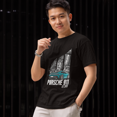 Man wearing a black t-shirt with Porsche 911 design against a dark background