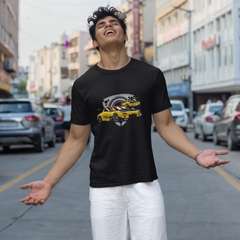 Person wearing a black t-shirt with a yellow graphic on a city street