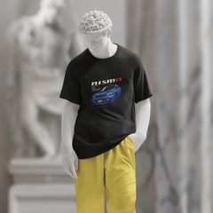 Mannequin wearing a black t-shirt with a graphic design and yellow pants in an indoor setting.