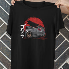 Black t-shirt with a graphic design of a car and red circle on a textured wall background