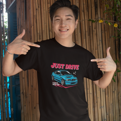 Person wearing a black t-shirt with a car graphic and text, pointing at the shirt.