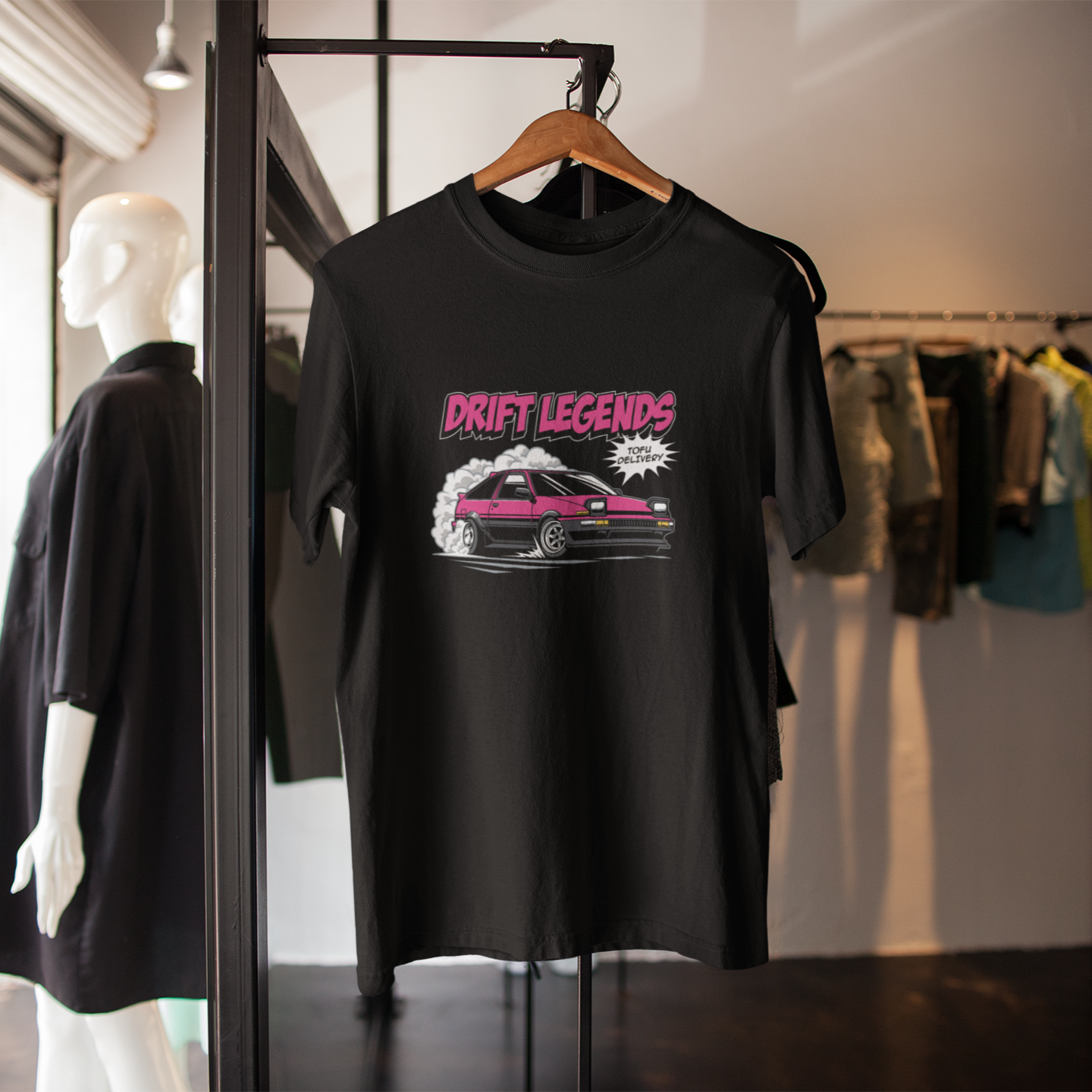 Black t-shirt with 'Drift Legends' design on a hanger in a clothing store.