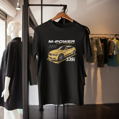 Black t-shirt with car graphic and 'M-Power' text on a mannequin in a store setting.