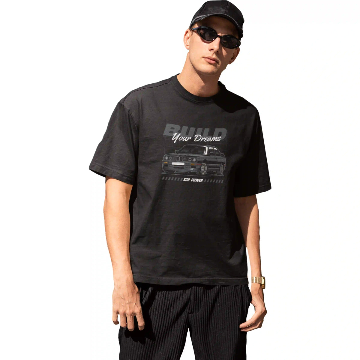 Two men in a casual setting, one using a phone and the other sitting at a table with a laptop.