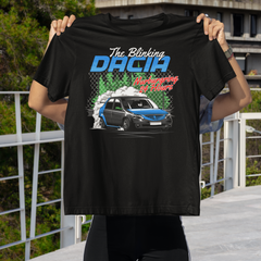 Person holding a black t-shirt with Dacia branding and car graphic against a scenic background.