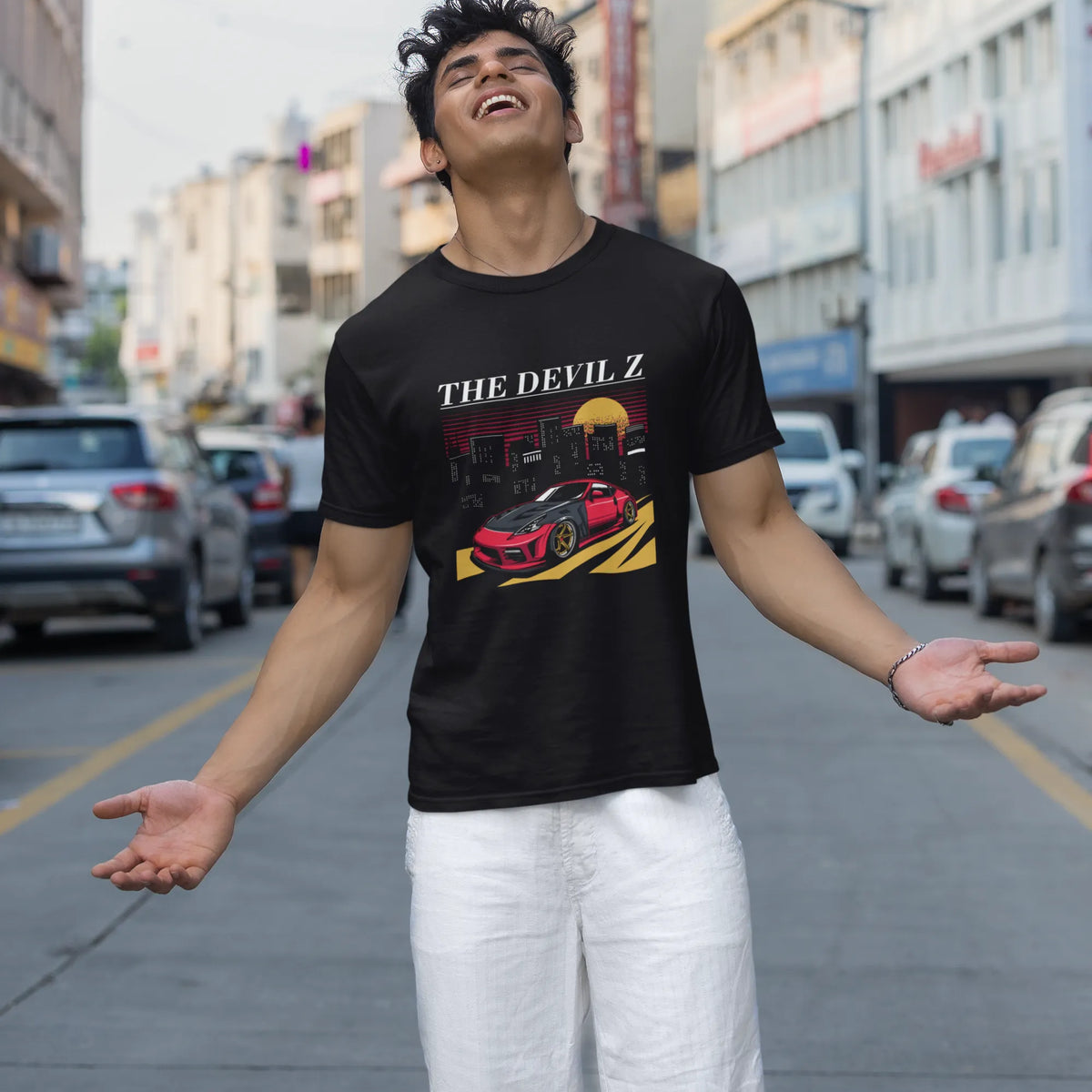 Man wearing a black t-shirt with graphic design on a city street