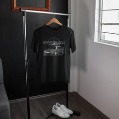Black t-shirt with Mercedes-Benz logo on a hanger in a room with a window.