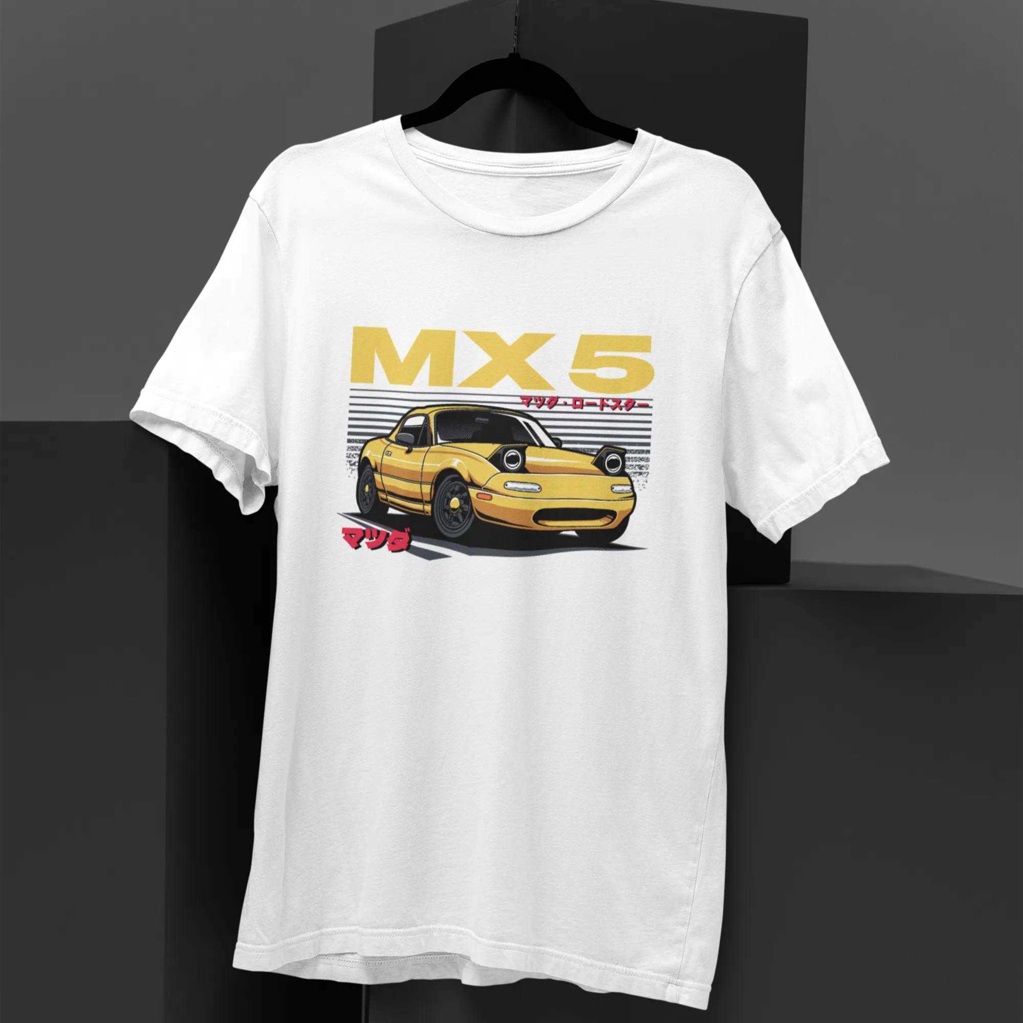 White t-shirt with yellow car graphic and 'MX 5' text on a black background