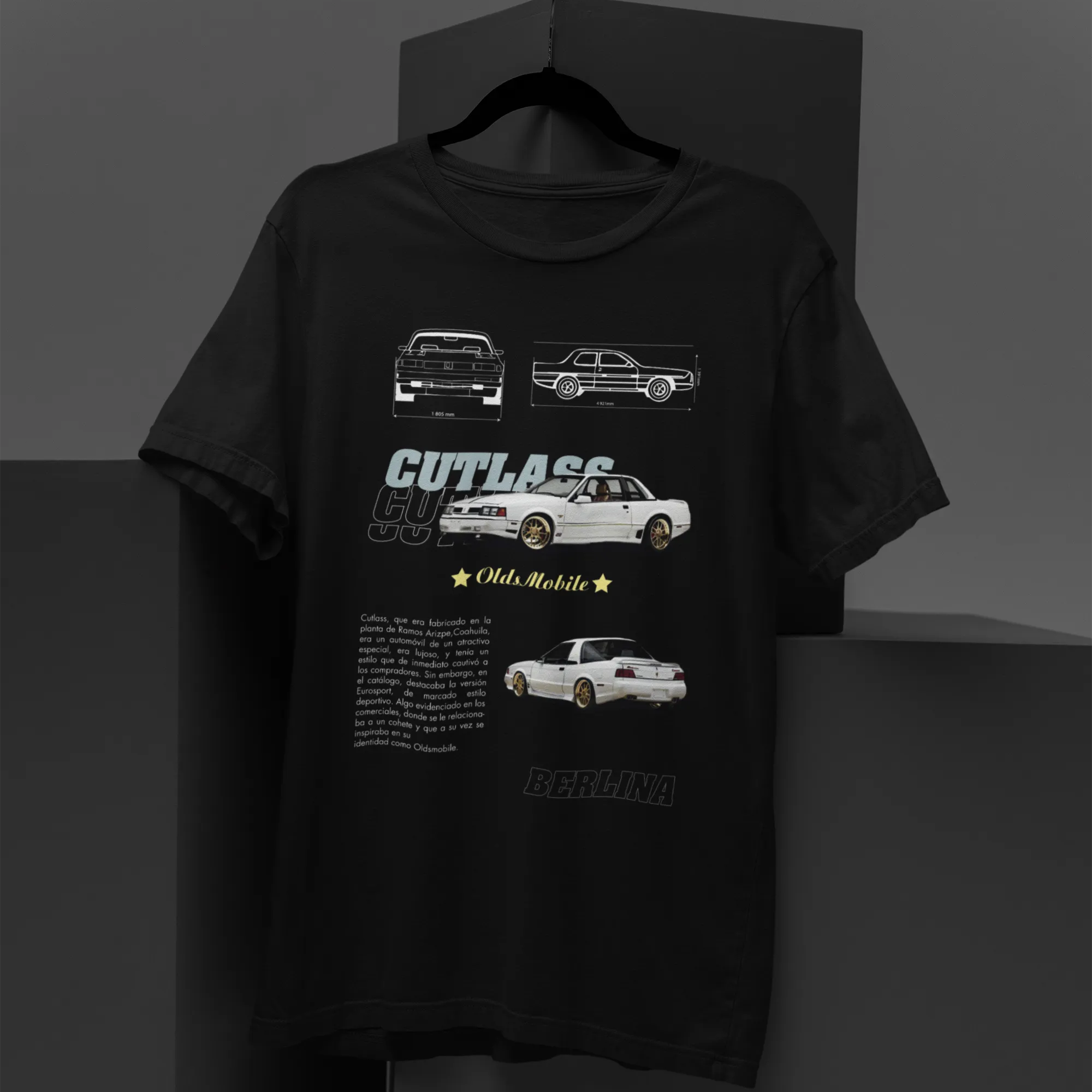 Black t-shirt with car illustrations and text on a gray background