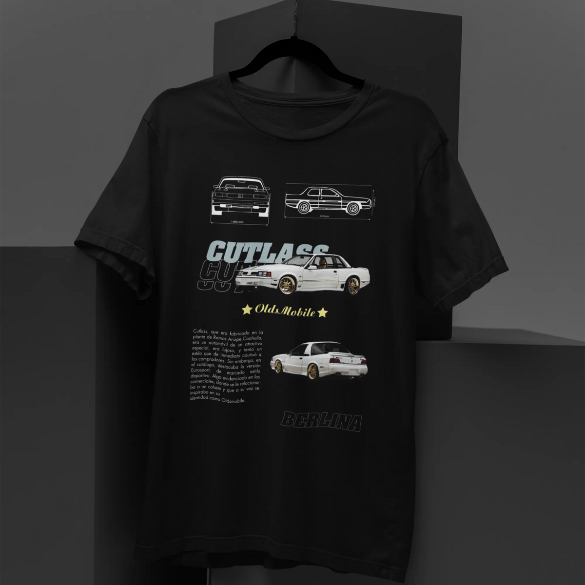 Black t-shirt with car illustrations and text on a gray background