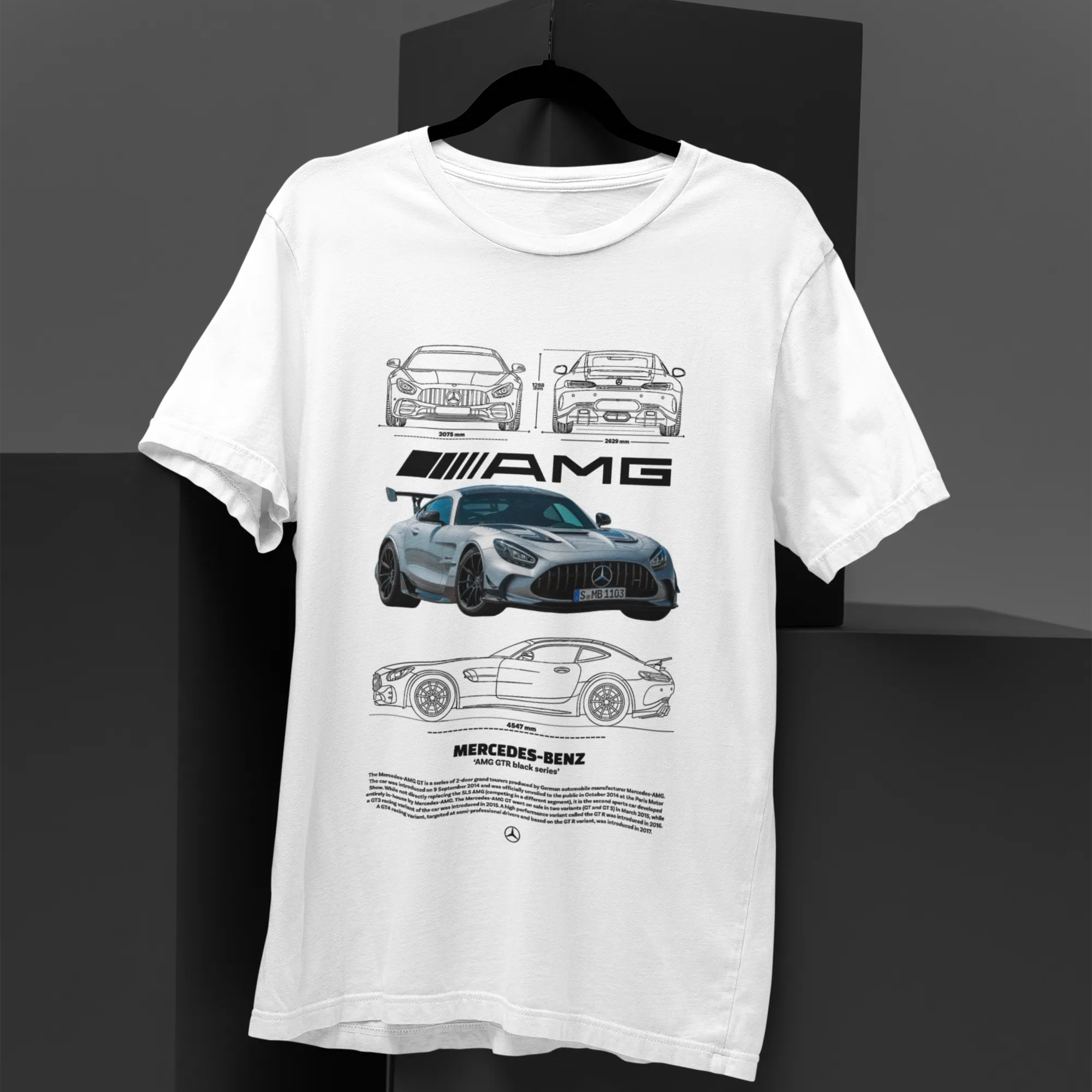 White t-shirt with black car graphics on a dark background