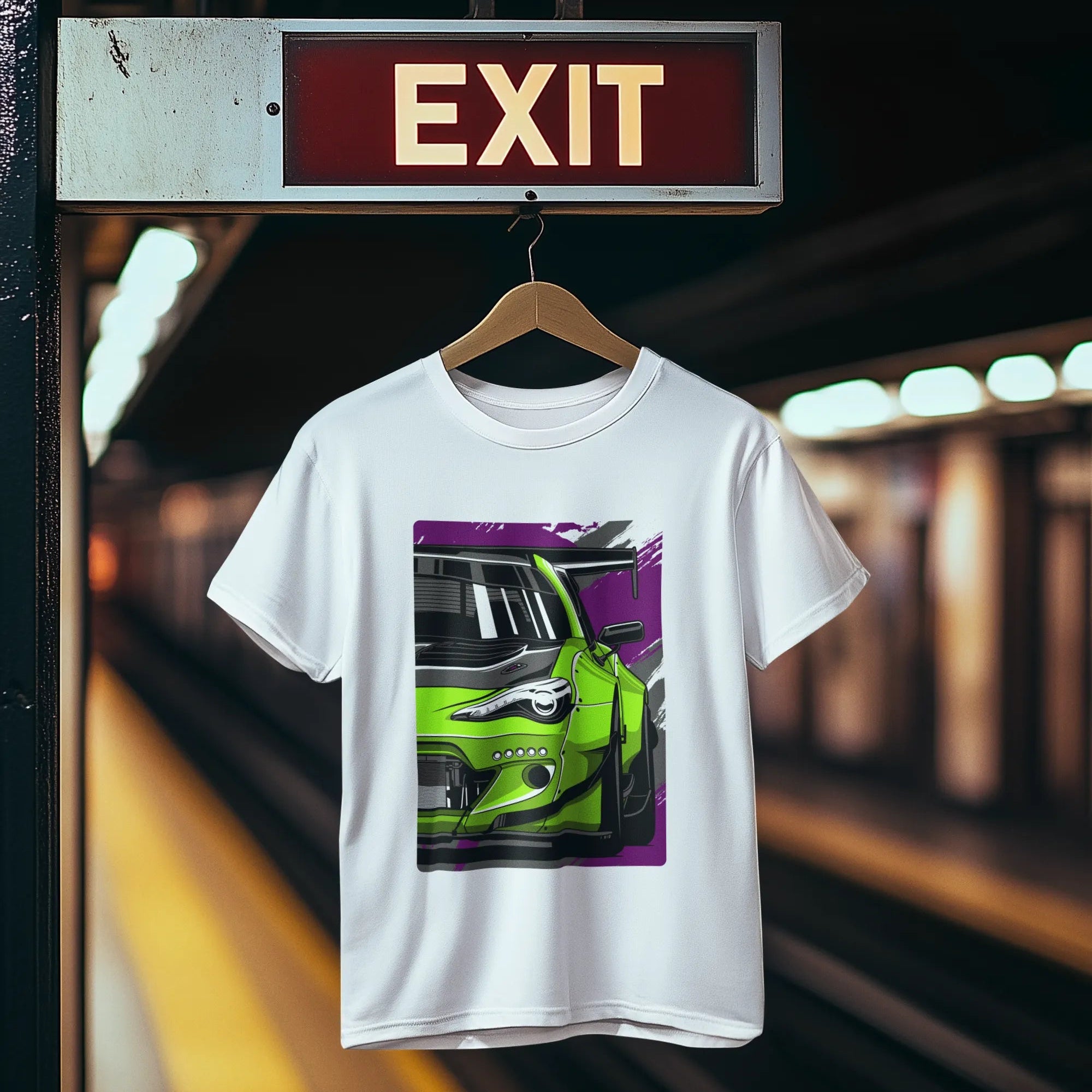 White t-shirt with a car graphic hanging on a hanger under an exit sign.