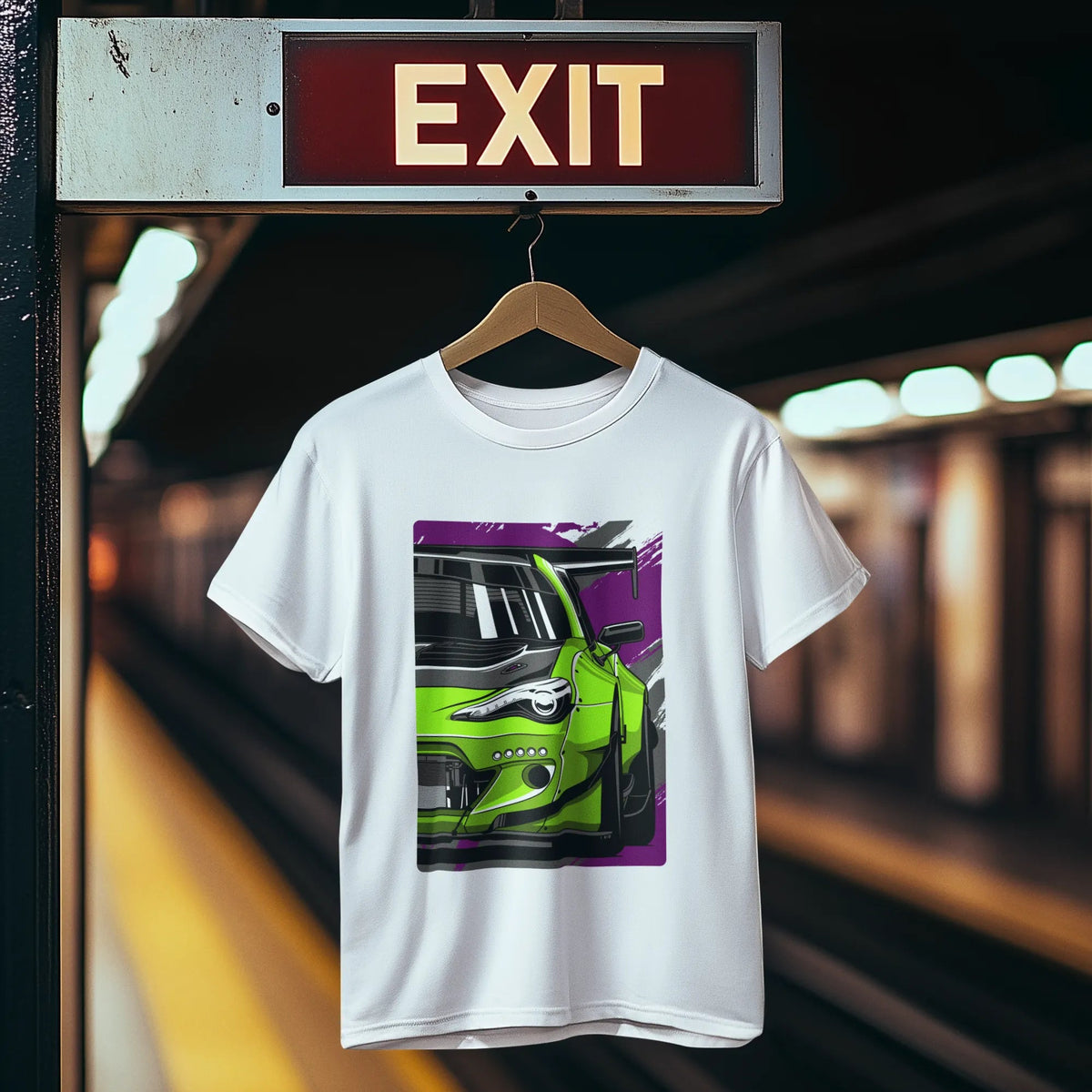White t-shirt with a car graphic hanging on a hanger under an exit sign.