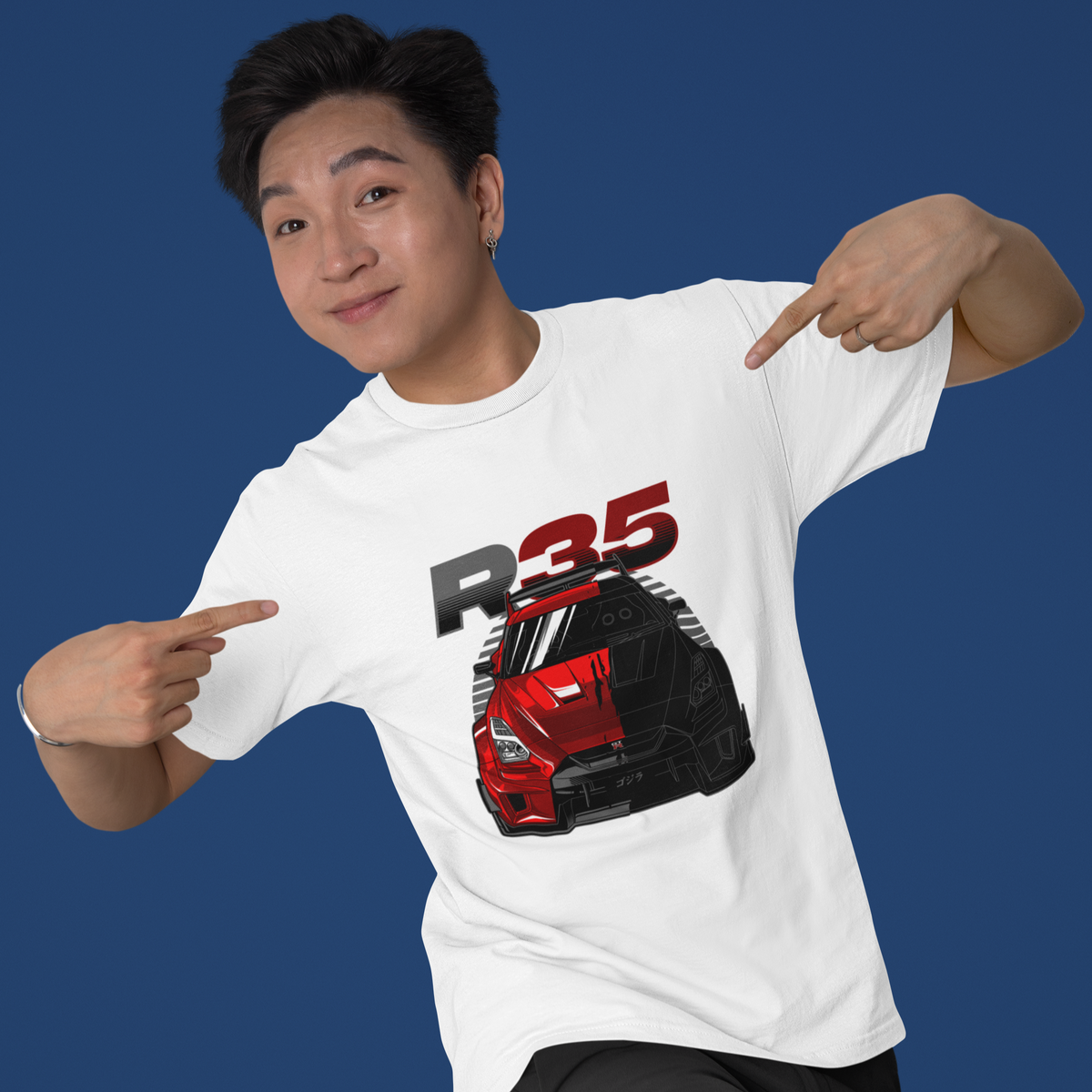 Person wearing a white t-shirt with a red and black car graphic and 'R35' text on a blue background