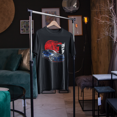 Black t-shirt with graphic design on a hanger in a room with dark walls and furniture.