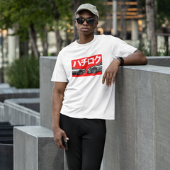 Person wearing a white t-shirt with a red and black graphic design, standing outdoors.